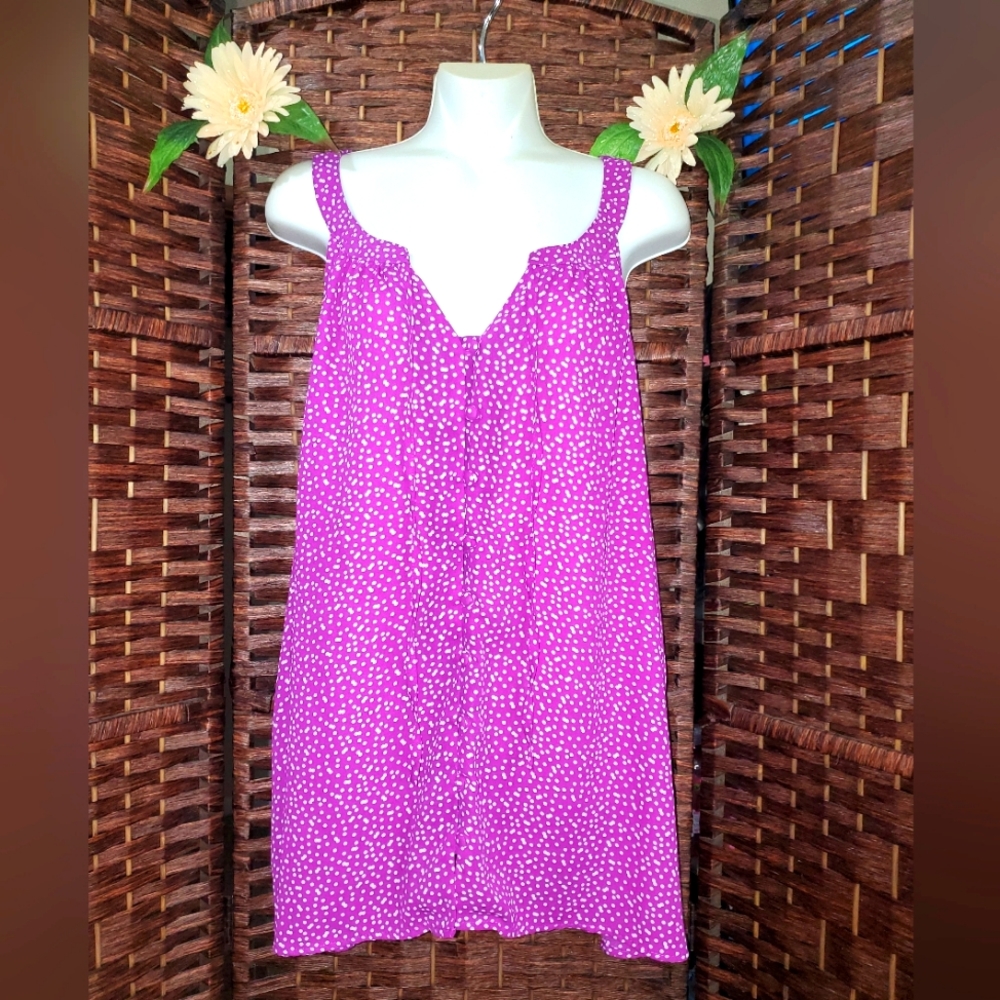 Torrid thank blouse color purple with white dots it is beautiful and it opens co